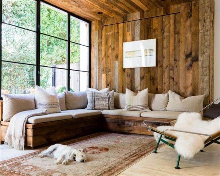 vintage-inspired-wooden-pallet-corner-sofa-with-white-cushions-and-pillows